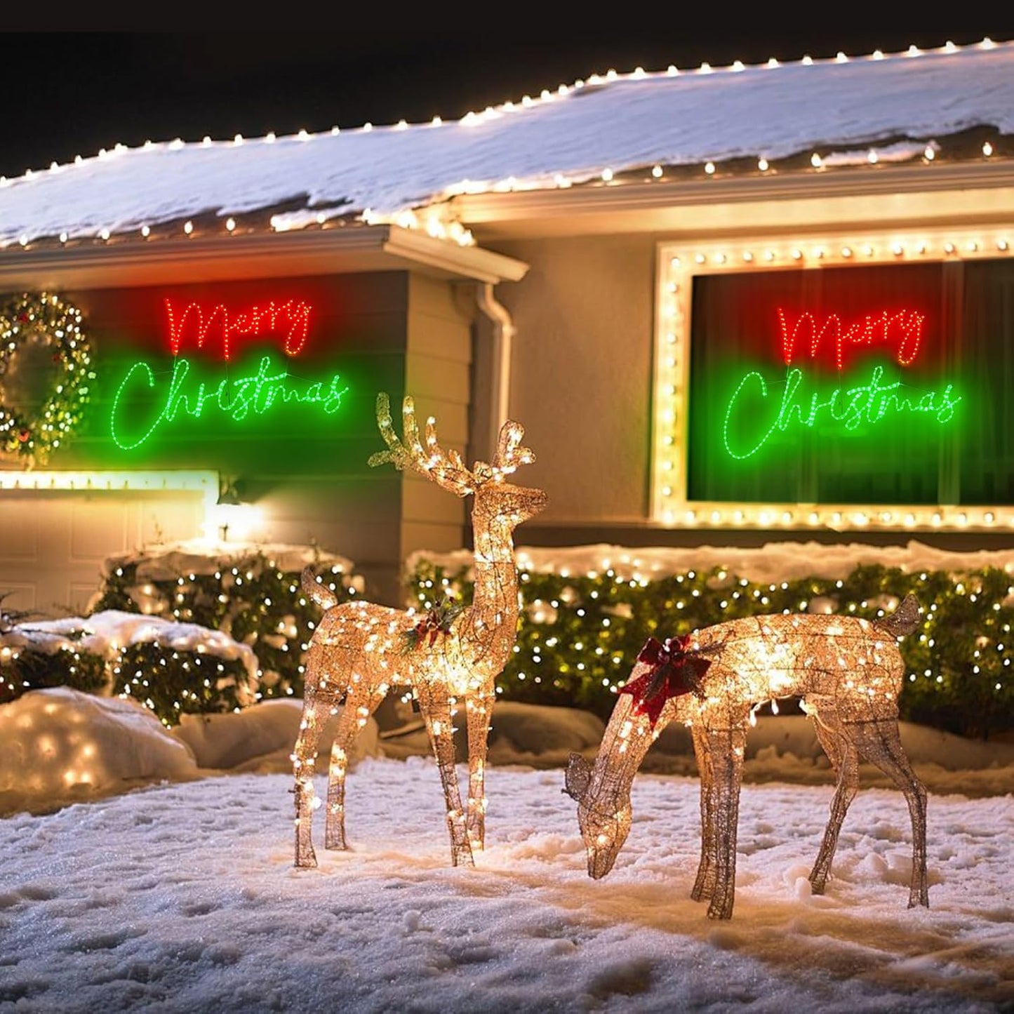 Decorative light-up deer figures in front of a house with 'Merry Christmas' signs.