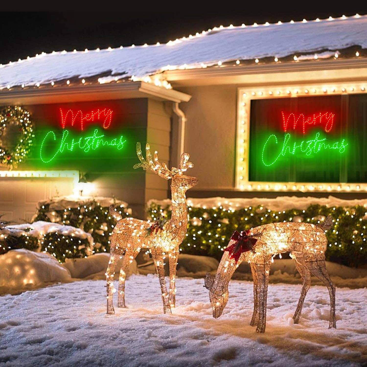 Decorative light-up deer figures in front of a house with 'Merry Christmas' signs.