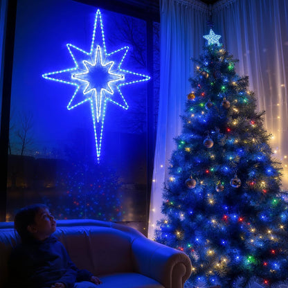 Person sitting on a couch in front of a decorated Christmas tree with a large blue star light fixture.